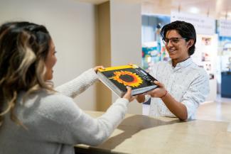 Image of student receiving book